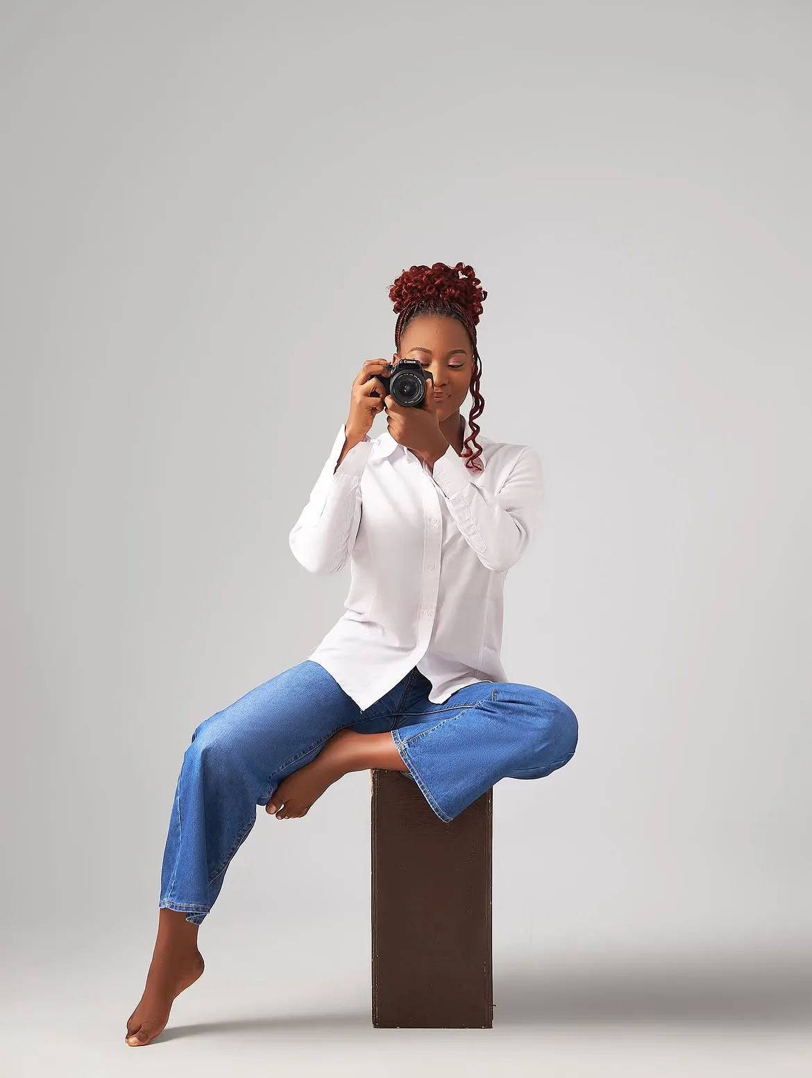 Patricia holding a camera in the studio