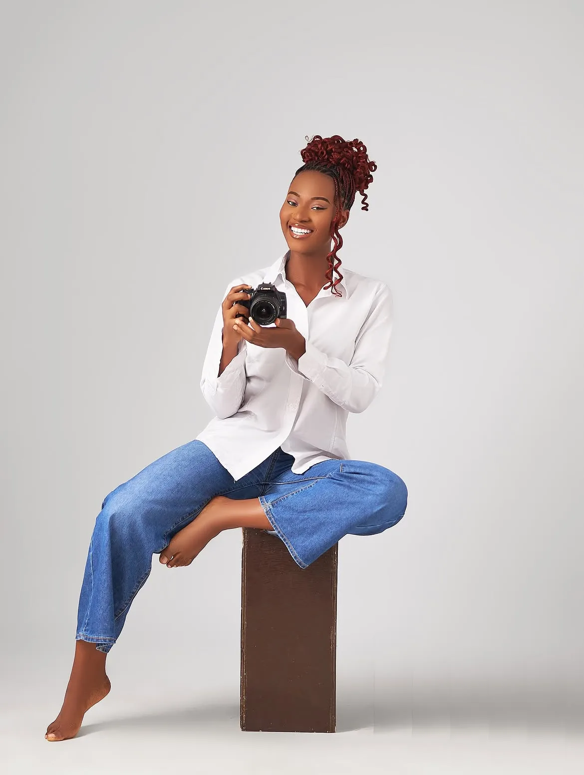 Patricia smiling with a camera